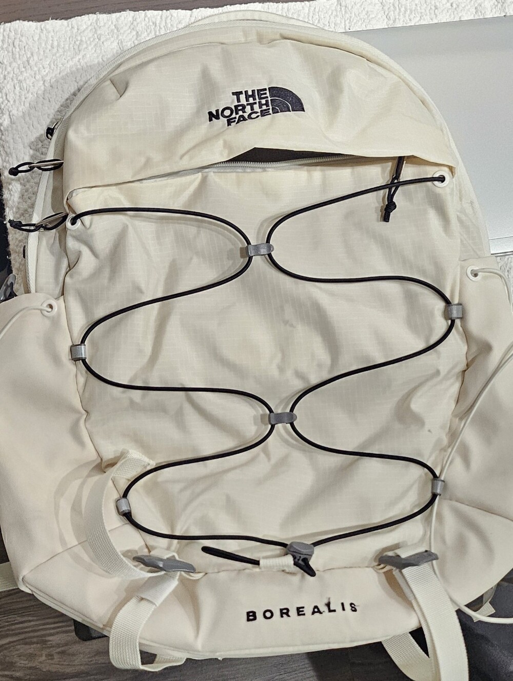 The North Face Borealis Backpack in White Cream with Black Bungee